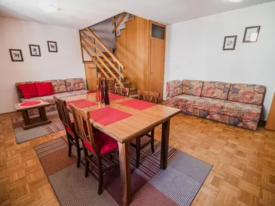 a living room with a table and a couch at Bovec Picturesque Mountain Vista Residences - Two Bedroom Apartment in Bovec