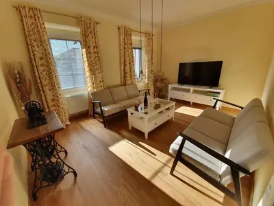 a living room with a couch and a tv at Komen Getaway Holiday Home with Balcony - Four Bedroom Holiday Home with Balcony in Komen