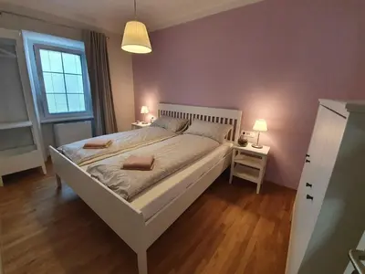 a bedroom with a large white bed with two lamps at Komen Getaway Holiday Home with Balcony - Four Bedroom Holiday Home with Balcony in Komen