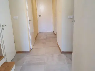 a hallway with two doors and a tile floor at Komen Getaway Holiday Home with Balcony - Four Bedroom Holiday Home with Balcony in Komen