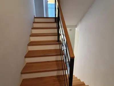 a staircase with wood and metal railings in a house at Komen Getaway Holiday Home with Balcony - Four Bedroom Holiday Home with Balcony in Komen
