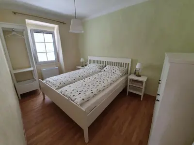 a white bed in a room with a window at Komen Getaway Holiday Home with Balcony - Four Bedroom Holiday Home with Balcony in Komen