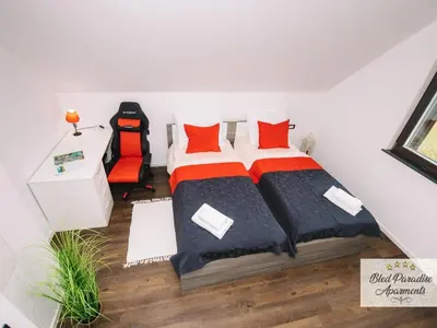 a bedroom with a bed with red pillows at Bled Prestigious and Stylish Apartments - Two Bedroom Apartment with Balcony in Bled