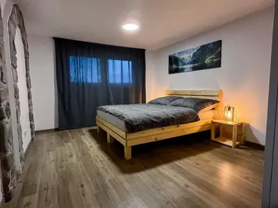 a bedroom with a bed and a window at Modern and Peaceful Apartment with Terrace - Two Bedroom Apartment with Terrace in Rečica ob Savinji