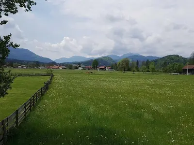 a field of green grass with mountains in the background at Modern and Peaceful Apartment with Terrace - Two Bedroom Apartment with Terrace in Rečica ob Savinji