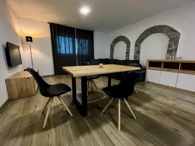a dining room with a wooden table and chairs at Modern and Peaceful Apartment with Terrace - Two Bedroom Apartment with Terrace in Rečica ob Savinji