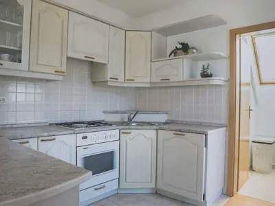 a kitchen with white appliances and white cabinets at Comfortable Apartment with Mountain View - One Bedroom Apartment in Bovec