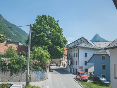 a street in a town with mountains in the background at Comfortable Apartment with Mountain View - One Bedroom Apartment in Bovec