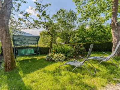 two chairs sitting in the grass in a garden at Nature Hideaway Holiday Homes with Sauna - Two Bedroom Holiday Home in Slappe dʼIdria