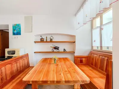 a kitchen with a wooden table in a room at Nature Hideaway Holiday Homes with Sauna - Two Bedroom Holiday Home in Slappe dʼIdria
