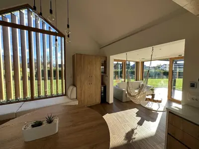 a living room with a hammock in the middle of the room at Elegant Warm Bliss Hideaway Escape Lodge - Holiday Home with Hot-Tub in Šenčur