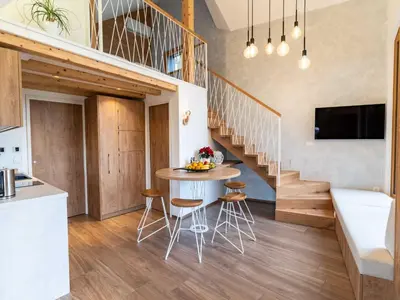 a kitchen and dining room with a table and chairs at Elegant Warm Bliss Hideaway Escape Lodge - Holiday Home with Hot-Tub in Šenčur