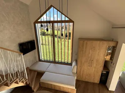 a room with a staircase with a large window at Elegant Warm Bliss Hideaway Escape Lodge - Holiday Home with Hot-Tub in Šenčur