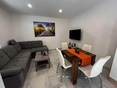 a living room with a couch and a table at Delightful Cozy Riverside Apartment - One Bedroom Apartment with Terrace in Rečica ob Savinji