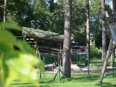 a pavilion in a park with a tree at Delightful Cozy Riverside Apartment - One Bedroom Apartment with Terrace in Rečica ob Savinji
