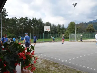 a group of people playingbasketball on a basketball court at Delightful Cozy Riverside Apartment - One Bedroom Apartment with Terrace in Rečica ob Savinji