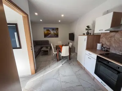 a kitchen and dining room with a table and a room at Delightful Cozy Riverside Apartment - One Bedroom Apartment with Terrace in Rečica ob Savinji