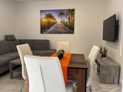a living room with a table and a couch at Delightful Cozy Riverside Apartment - One Bedroom Apartment with Terrace in Rečica ob Savinji