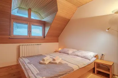 a bedroom with a bed with two towels on it at Oblak Estate Apartments in Ortnek