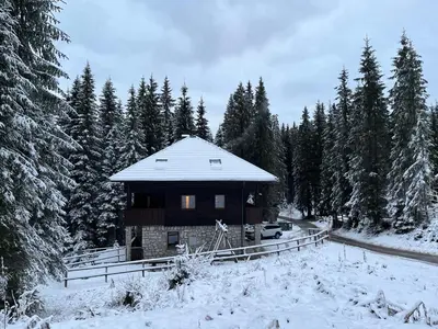 a building with a snow covered roof in the snow at Triglav NP Apartment - above Bled in Zgornje Gorje