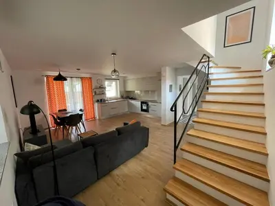 a living room with a couch and a staircase at Spacious 2 bed Villa near Spa Town Rogaska Slatina in Rogaška Slatina