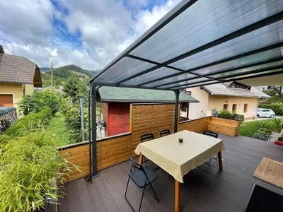 a patio with a table on a deck at Spacious 2 bed Villa near Spa Town Rogaska Slatina in Rogaška Slatina