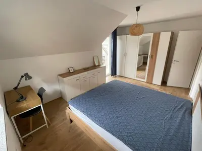 a bedroom with a bed and a desk and a mirror at Spacious 2 bed Villa near Spa Town Rogaska Slatina in Rogaška Slatina