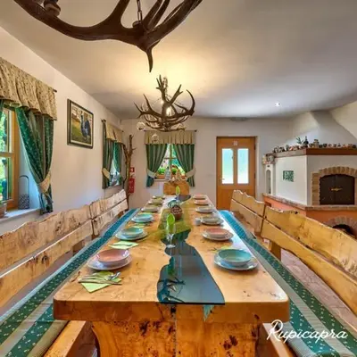 a long wooden table in a living room at Rupicapra Holiday Mountain House in Kostel