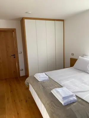 a bedroom with a bed with two towels on it at Hiša nad izvirom reke Krke in Krka