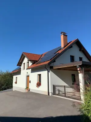 a white house with a driveway at Hiša nad izvirom reke Krke in Krka