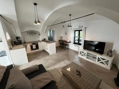 a living room with a couch and a tv at City Center Deluxe in Kranj