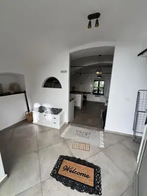 a room with a white wall and a rug on the floor at City Center Deluxe in Kranj