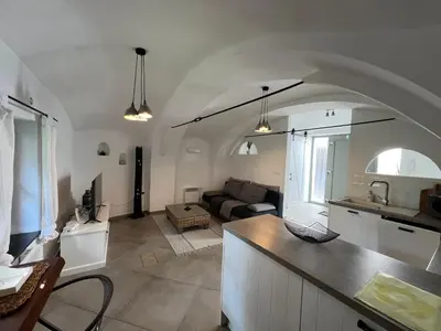 a kitchen and living room with a couch and a table at City Center Deluxe in Kranj