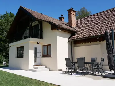 a house with a table and chairs in front of it at Hidden View House