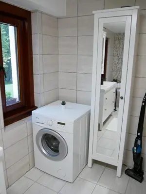 a washing machine in a bathroom with a sink at Hidden View House