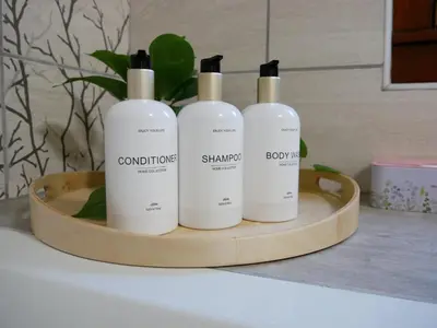 three bottles of shampoo sitting on a wooden tray at Hidden View House