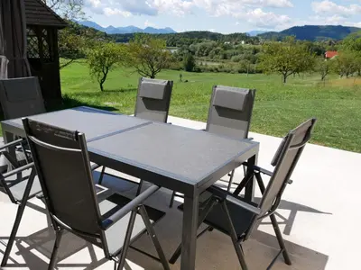 a table and chairs with a view of a field at Hidden View House