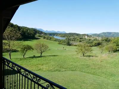 a balcony with a view of a field of grass at Hidden View House