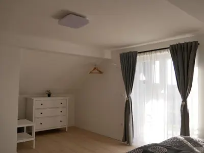 a bedroom with a bed and a dresser and a window at Hidden View House