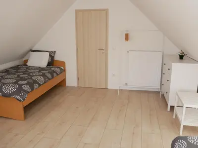 a bedroom with a bed and a wooden floor at Hidden View House