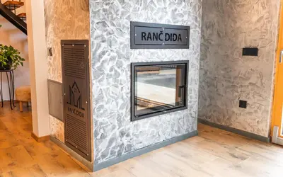 a mirror on a wall in a room at RANČ Dida