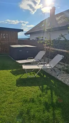 two lounge chairs and a pool in a yard at RANČ Dida