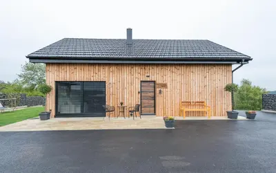 a small wooden building with a table and chairs at RANČ Dida