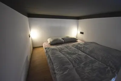 a bedroom with a bed with two pillows on it at Apartma Fontana in Ljubljana