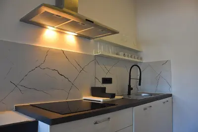 a kitchen with a counter with a sink and a light at Apartma Fontana in Ljubljana