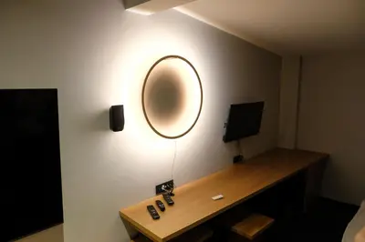 a room with a desk with a mirror on the wall at Hotel Kunst in Krško