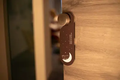 a close up of a wooden door with a handle at Hotel Kunst in Krško