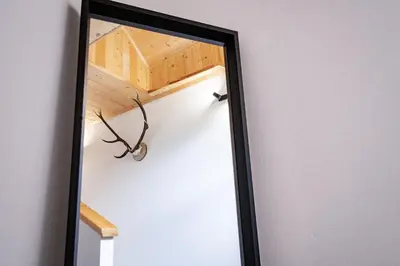 a mirror reflection of a hallway with a wooden ceiling at TDI - Modern 2-Bedroom Apartment in nature