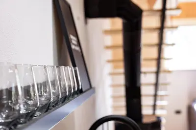 a row of wine glasses on a wall at TDI - Modern 2-Bedroom Apartment in nature