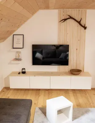 a living room with a large tv on a wall at TDI - Modern 2-Bedroom Apartment in nature